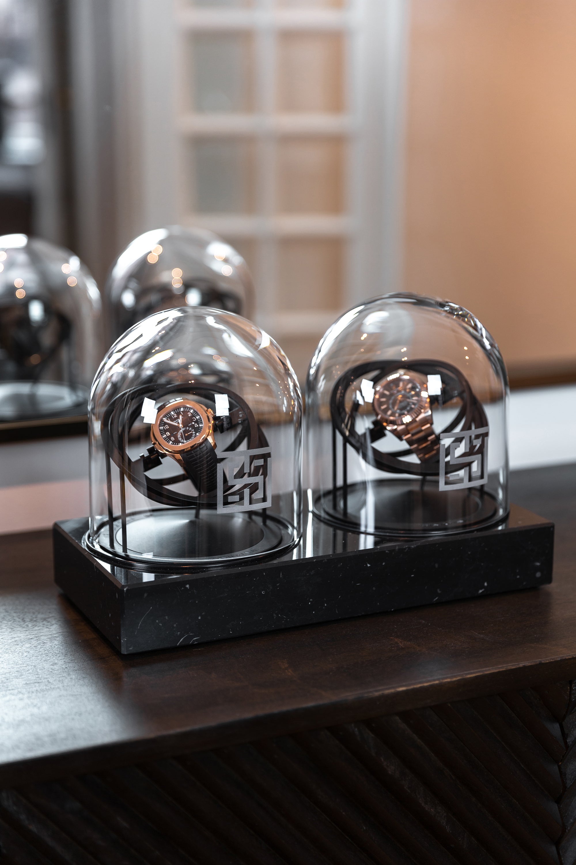 Two Planet Double Axis Black Watch Winder on table